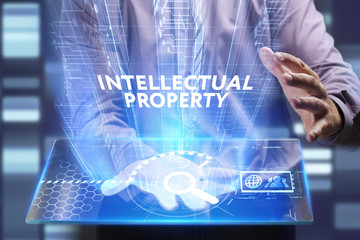 Business, Technology, Internet and network concept. Young businessman working on a virtual screen of the future and sees the inscription: Intellectual property