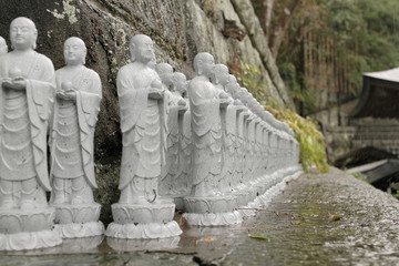 Jizo figures, buddha image for abort child, in Hasedera temple on raining day, Kamakura, Japan