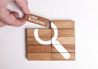 Business, Technology, Internet and network concept. Young businessman shows the word: Link building - obrazy, fototapety, plakaty