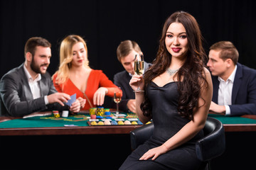 Young people playing poker at the table. Casino