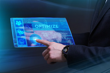 Business, Technology, Internet and network concept. Young businessman working on a virtual screen of the future and sees the inscription: Optimize