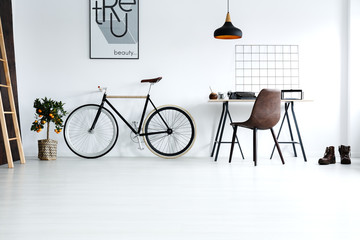 Simple, white room with bike - Powered by Adobe