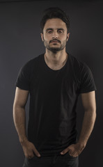 Caucasian guy wearing black T-shirt in studio 