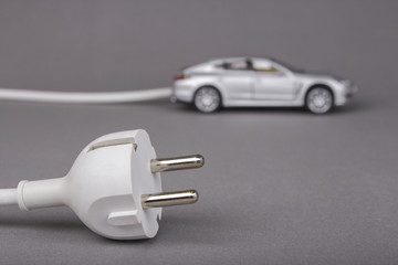 Electric car with plug from the outlet.