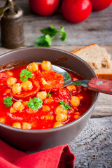Tomato soup with chickpeas and chorizo, selective focus