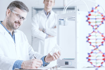 Fototapeta premium Scientist holding 3D printout