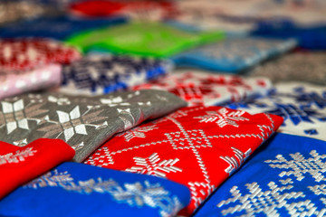 colored t-shirts neatly stacked on the counter of the store