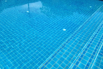 Swimming pool with stair and blue relaxing water