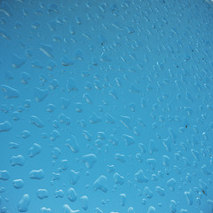 Water droplets on glass, sky background, close-up view, 3d rendering