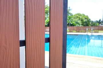 wooden door open to swimming pool in summer.