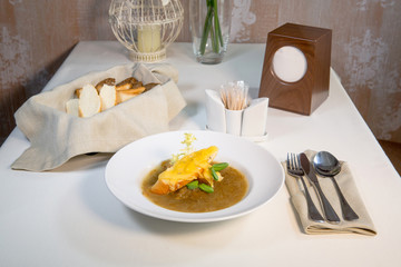 Onion soup on the table in a composition with a glass of wine and bread