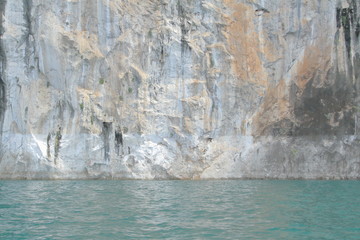 Beautiful rock cliff and emerald green water, Ratchaprapa dam, Khoa Sok national park, Suratthani, Thailand