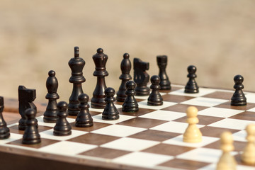 Close up wooden chess pieces on board Selective focus on black pieces