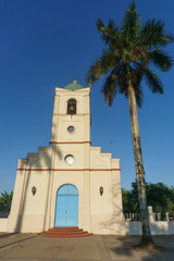 Fototapeta na wymiar Church in Vinales with palm tree, Vinales, Cuba