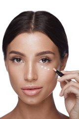 Beauty Woman Face Makeup. Female Applying Corrector Under Eyes