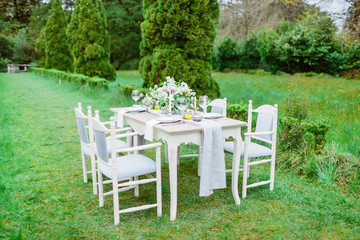 Table setting with dishes, cutlery and floristic. European wedding