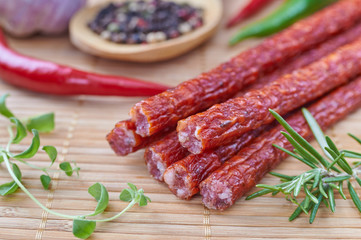 Snack stick sausage on a bamboo mat