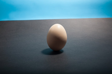 Egg standing on egg cup, isolated on white background