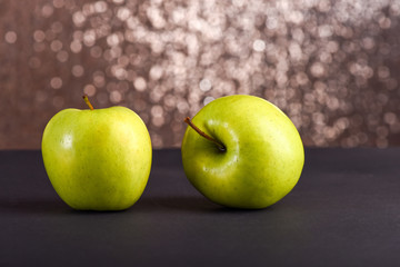 fresh green apples on grey table, sparkling background