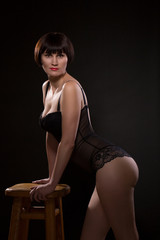 Brunette in lingerie on a black background