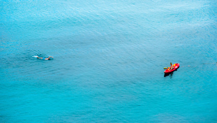 July 17, 2016 - Koh Tao, Thailand : A man snorkeling toward his friend on kayak.