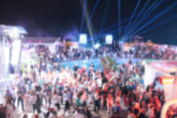 Blurry night club dj party people enjoy of music dancing sound with colorful light. club night light dj party Ibiza club. With Smoke Machine and lights. Dark background.