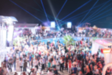 Blurry night club dj party people enjoy of music dancing sound with colorful light. club night light dj party Ibiza club. With Smoke Machine and lights. Dark background.