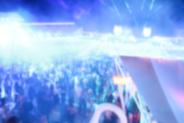 Blurry night club dj party people enjoy of music dancing sound with colorful light. club night light dj party Ibiza club. With Smoke Machine and lights. Dark background. © Alexey Lesik