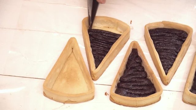 Adding tasty chokolate to the small tarts