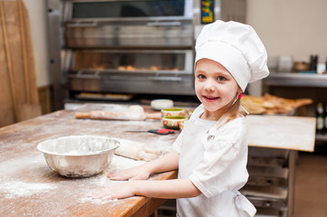 Portrait of a little chef cooking girl