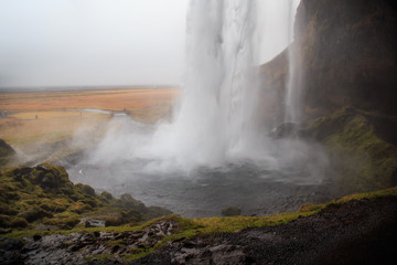 Seljalandsfoss waterfall in southern Iceland on a cloudy winter day. It is one of the largest waterfalls in the country.  