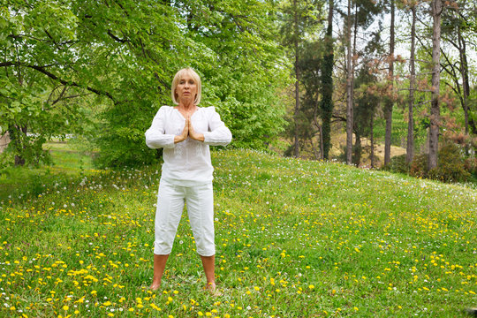 Senior blonde woman enjoying nature during a breathing exercise