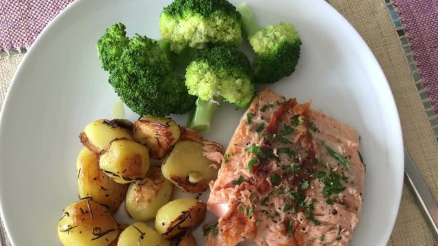 Plate of potatoes, salmon, and broccoli