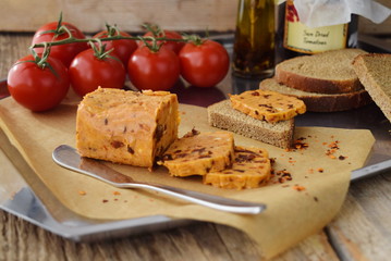 Homemade butter with sun-dried tomatoes for spreads on a backing paper. Healthy food concept
