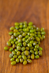 green mung beans on wooden surface