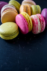assorted macaroons on black chalkboard