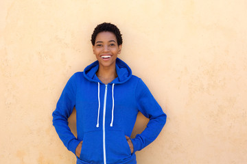 cool young woman smiling with blue sweatshirt