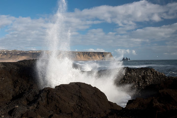 Famous Reynisdrangar rock formations at black Reynisfjara Beach in Iceland.
