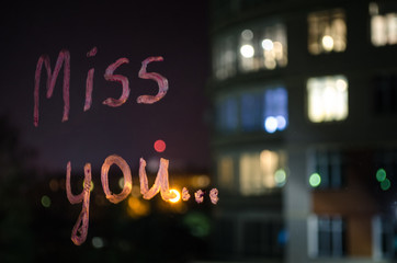 Love you, inscription (text) by lipstick on the window glass in the night. Love concept. Valentine background and love confession.