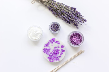 Fototapeta na wymiar lavender flowers in organic cosmetic set on white background top view mock-up