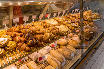 A set of croissants and bread in shop window