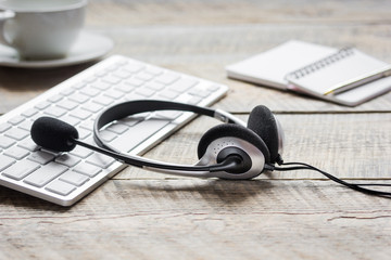 headset and keyboard on workdesk for call center concept