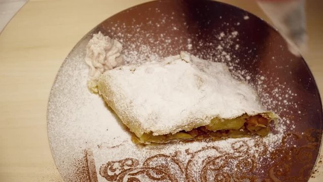 Tasty sweet strudel on the silver plate closeup
