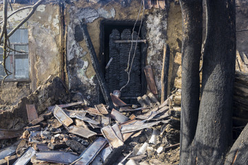 The charred entrance door