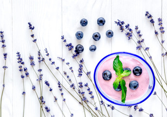 lavender desk design with blueberry yoghurt white background top view mock up