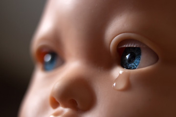 A doll with tears in her eyes. Emotions, children's insults