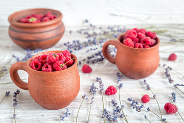 fresh raspberry and dry lavander in rustic design on wooden background