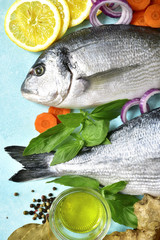 Uncooked organic dorado or sea bream with ingrediets for making.Top view .
