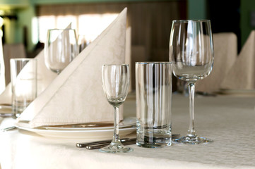 catering table set service with silverware, napkin and glass at restaurant before party