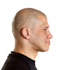 Fototapeta premium Portrait of a young shaved bald man in profile